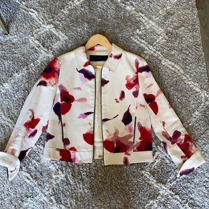 White blazer with pink and red colors.